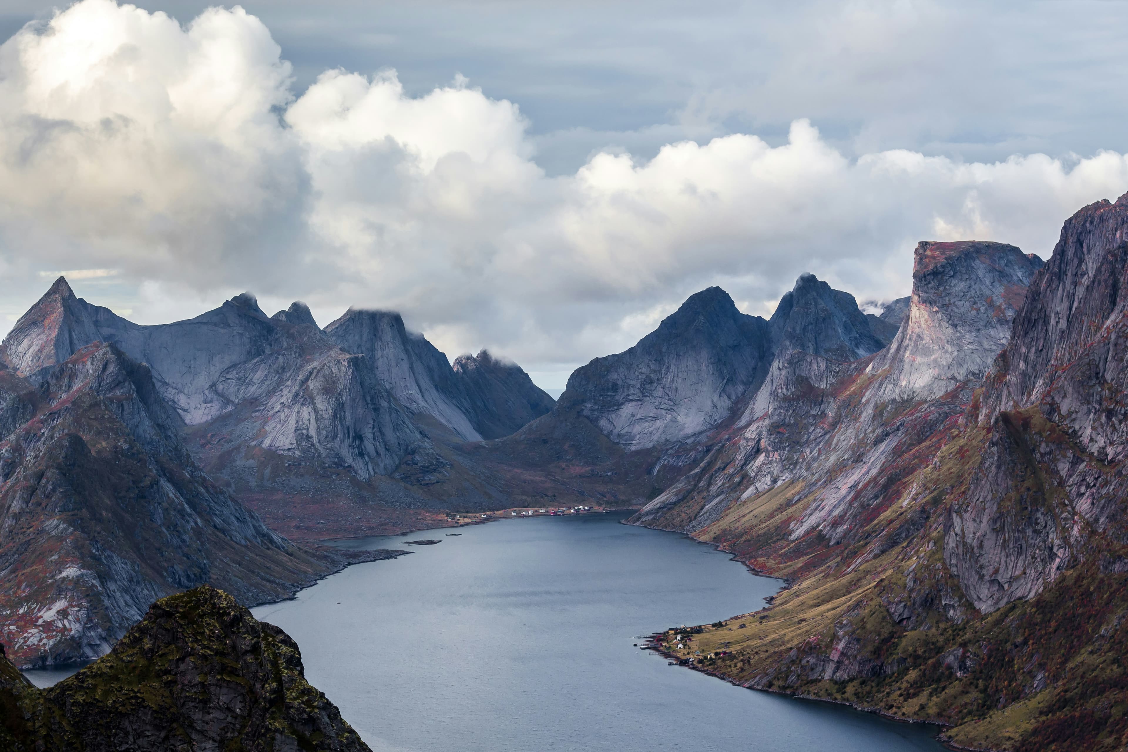 A wide fjord basin with steep mountains and low cloud