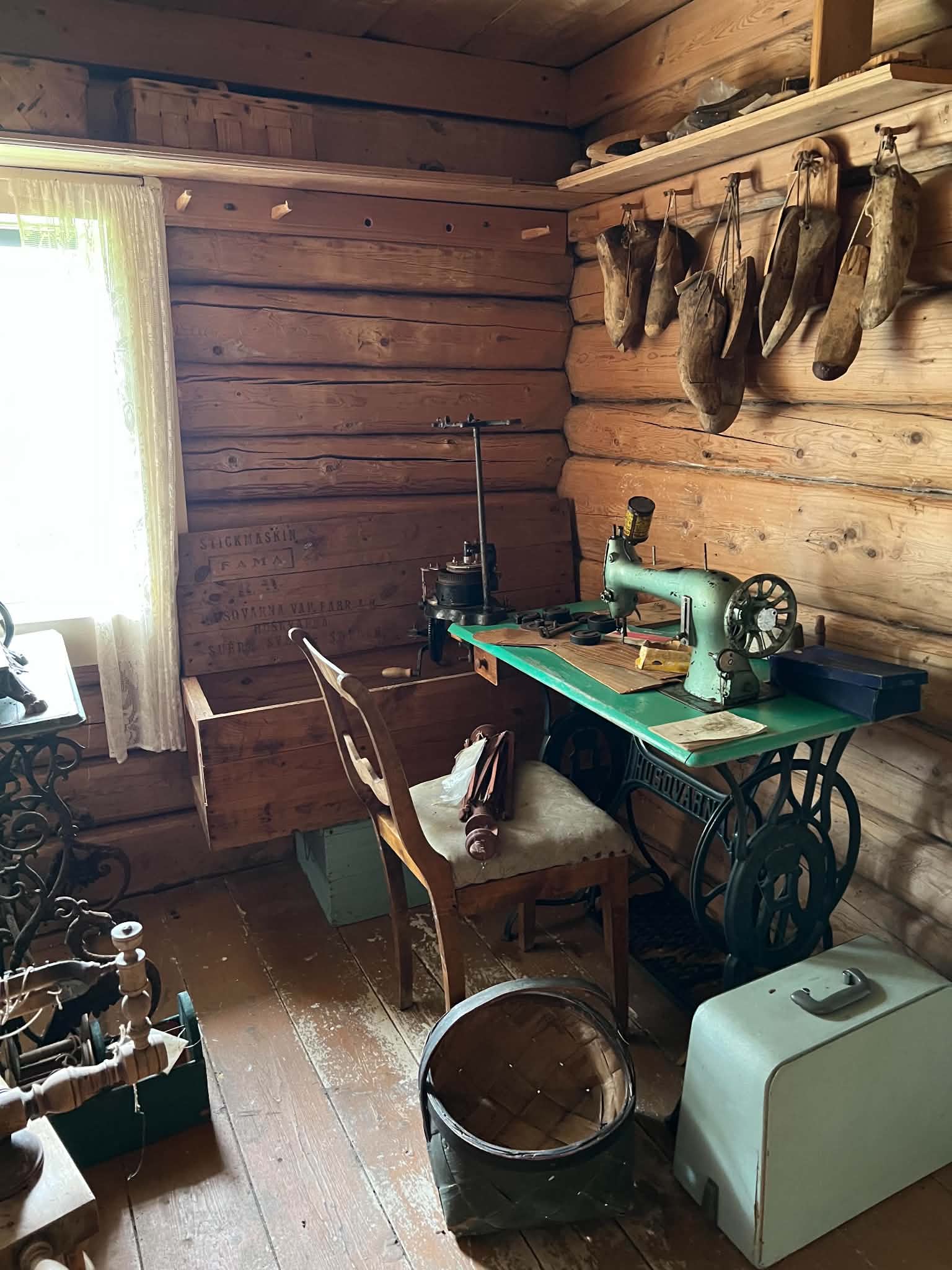 Historic sewing room with sewing machine and practical equipment