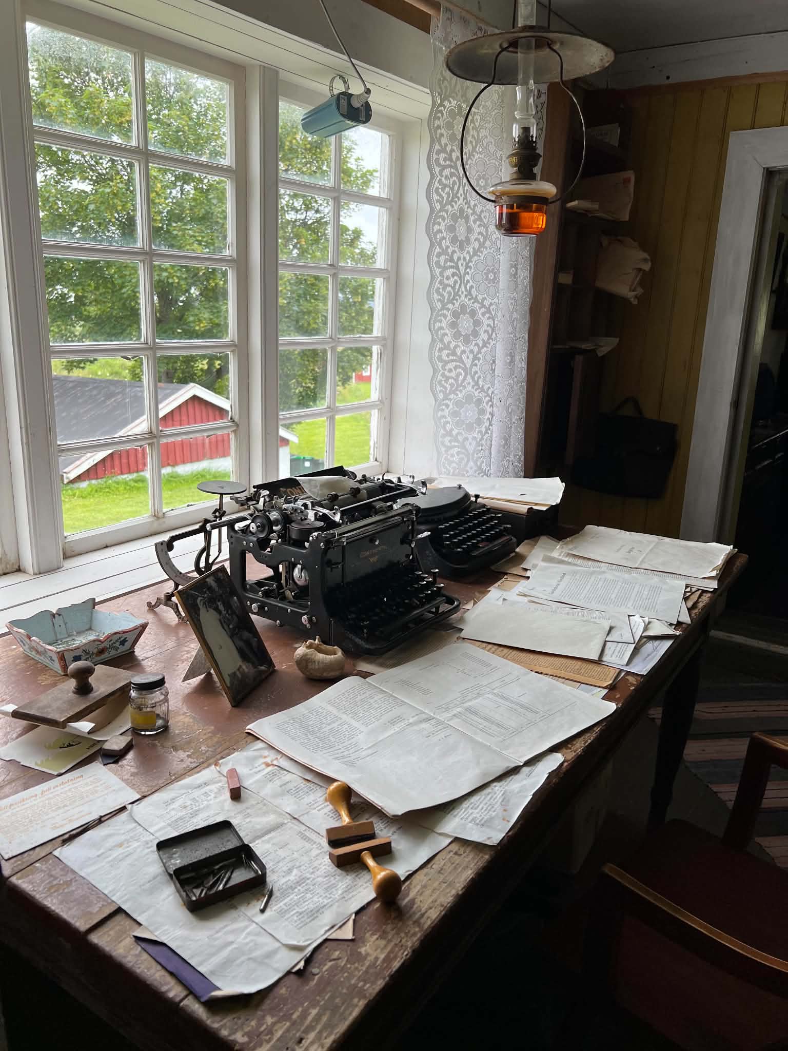 Typewriters, documents and writing tools on a historic worktable