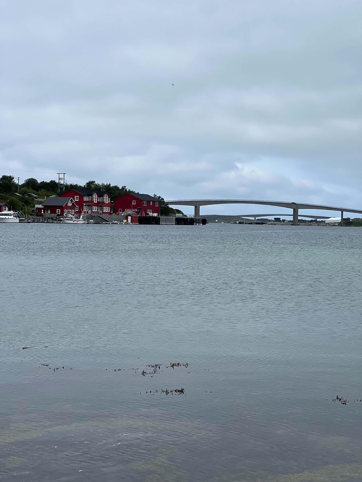 A low coastal bridge crossing sheltered water between the islands of Herøy.