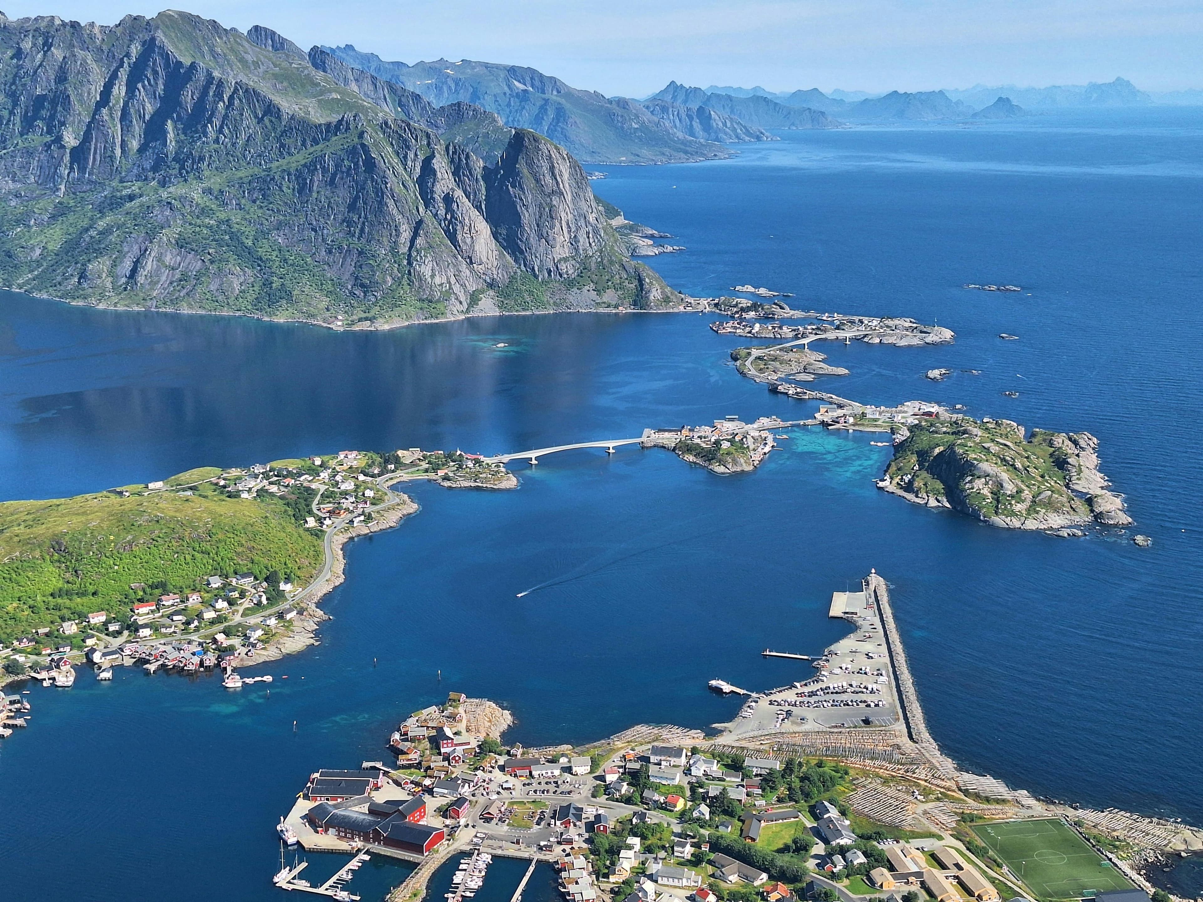 Rorbuer and steep mountains above the sea in Lofoten under soft Arctic light