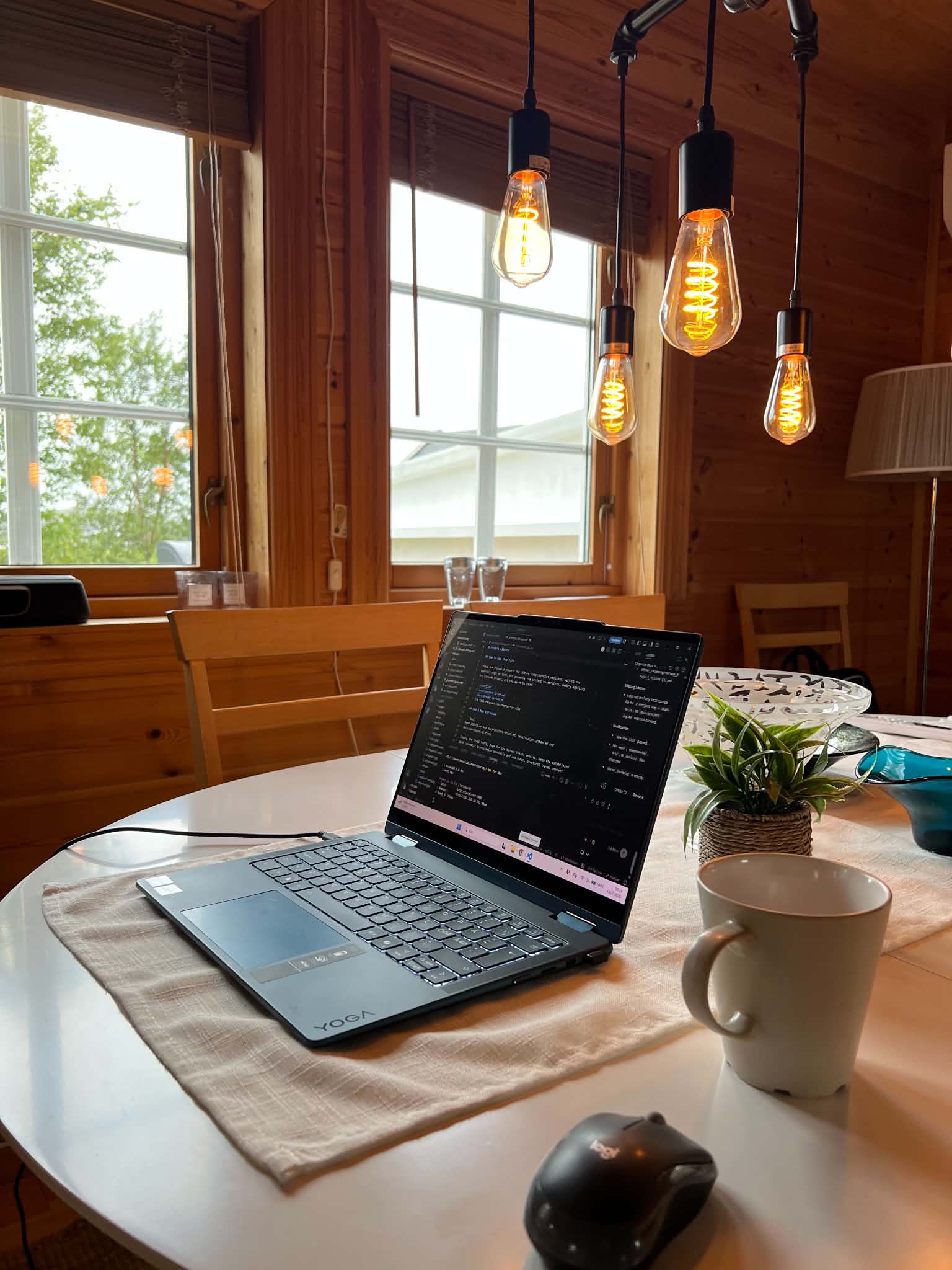 Laptop and coffee on a cabin table while working from Herøy