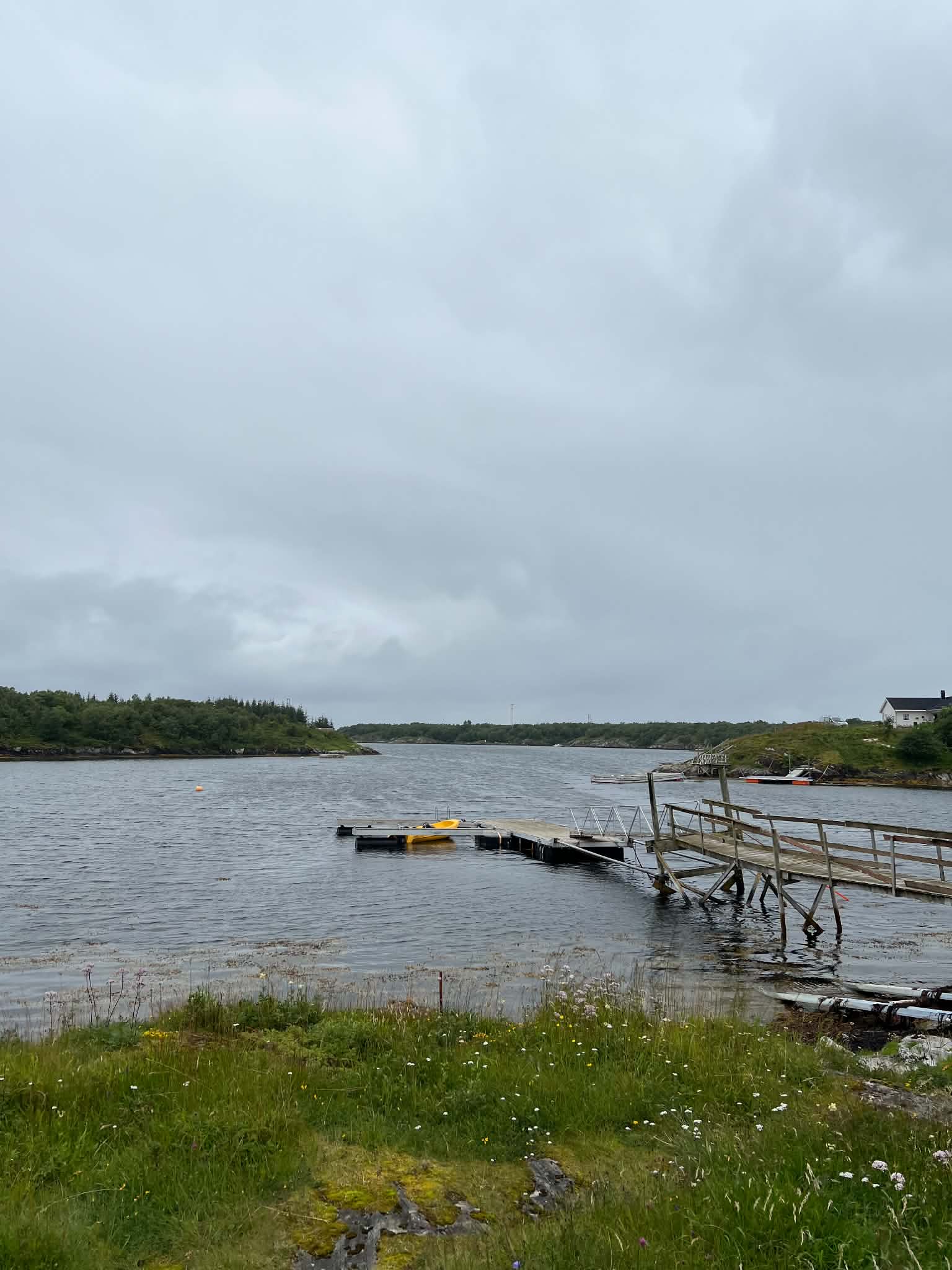 Floating dock and yellow kayak in sheltered coastal water on Herøy
