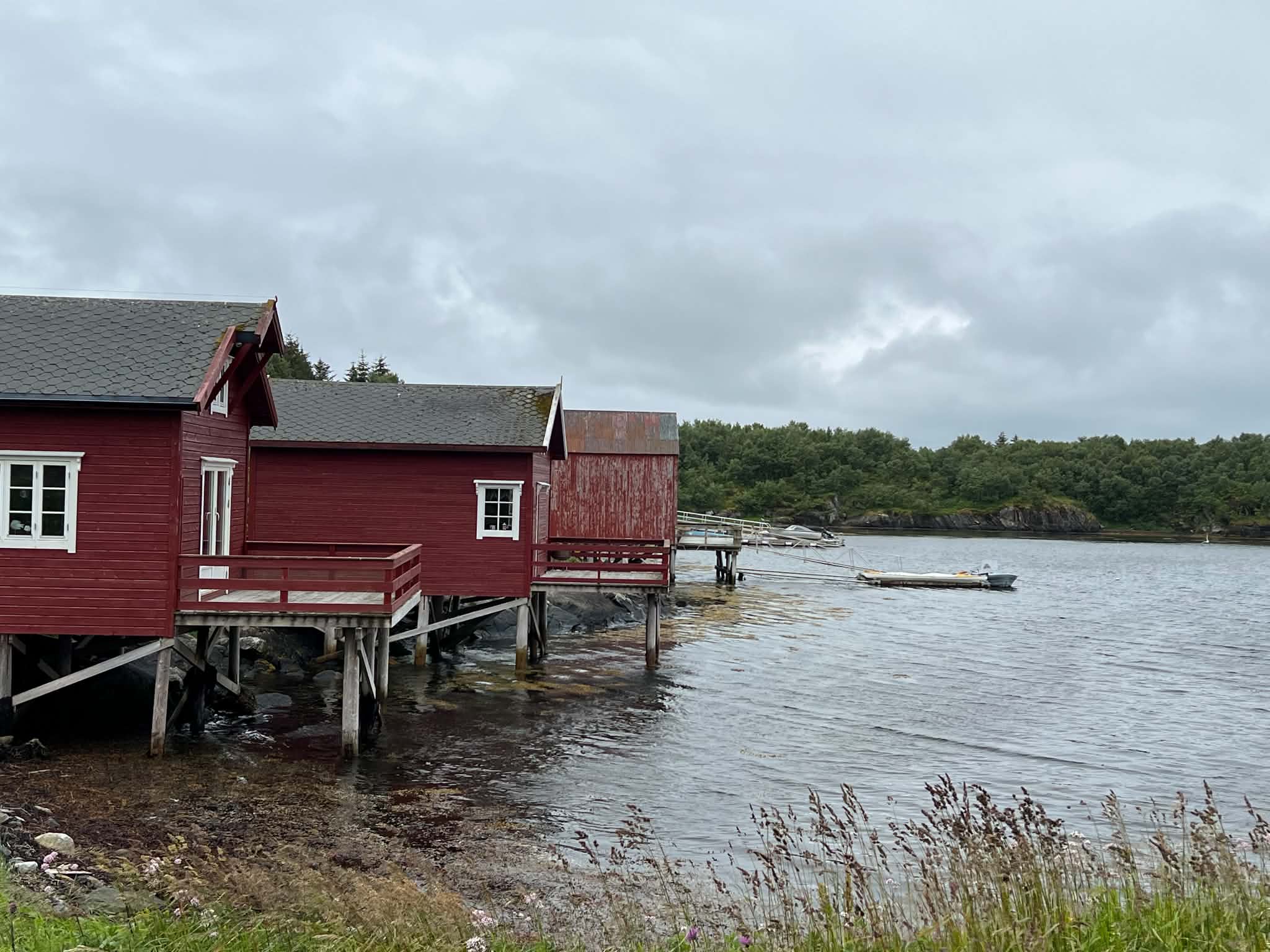 Traditional red boathouses beside the sea on Herøy, Helgeland