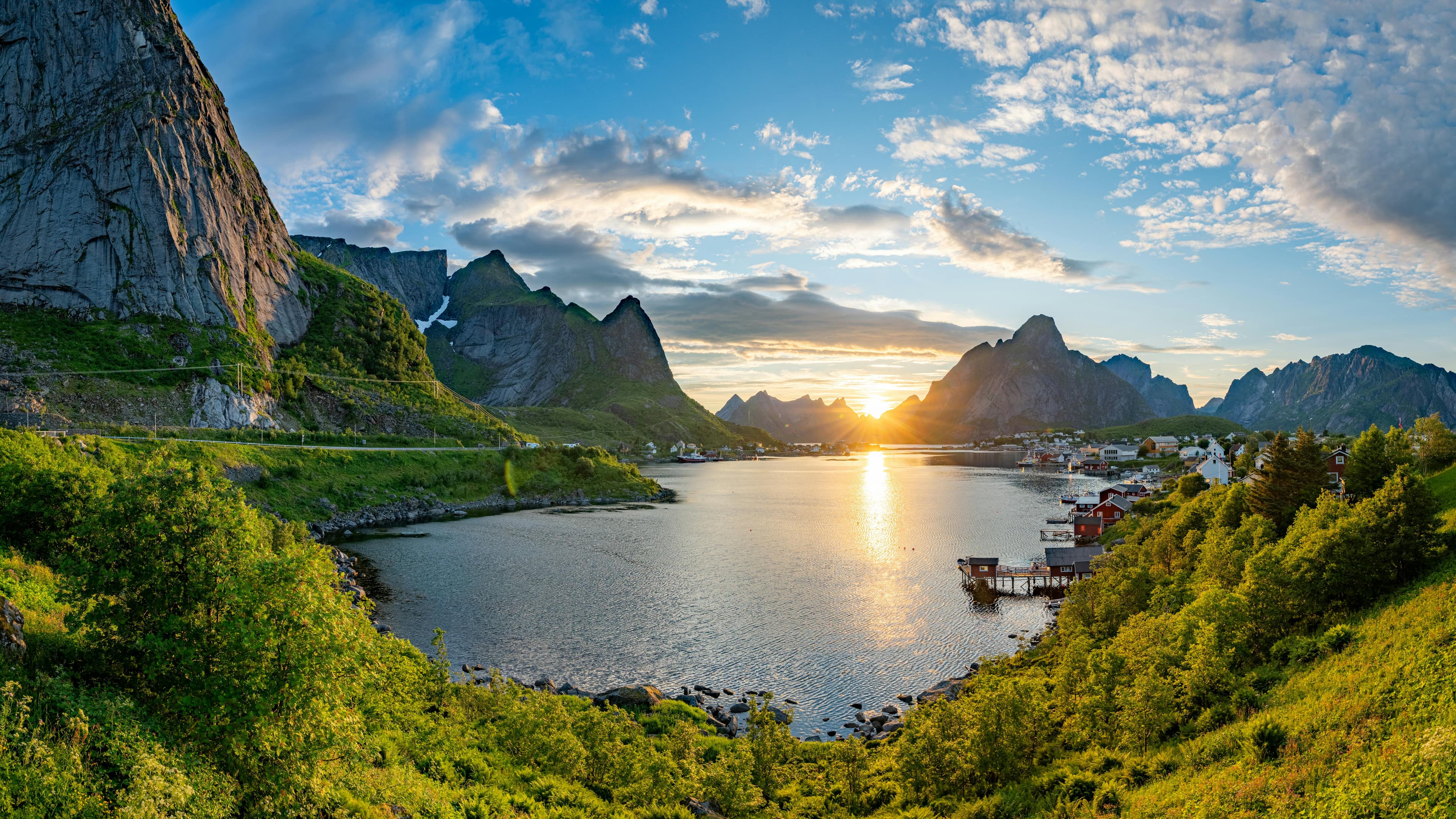 Sunset over the Helgeland coast with calm water and dark mountain shapes